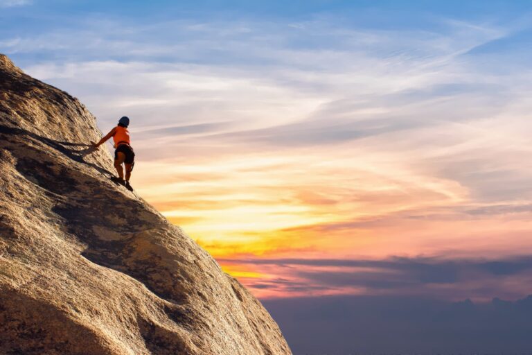 person climbing on mountain