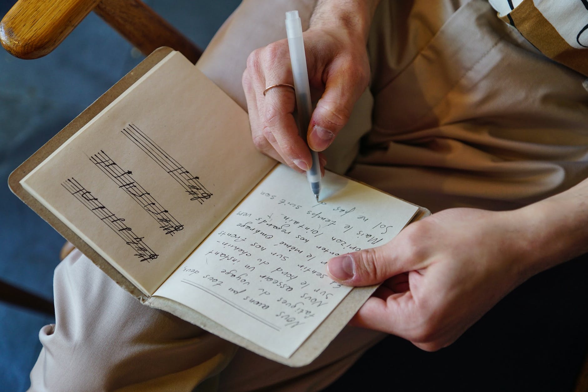 person writing in notebook