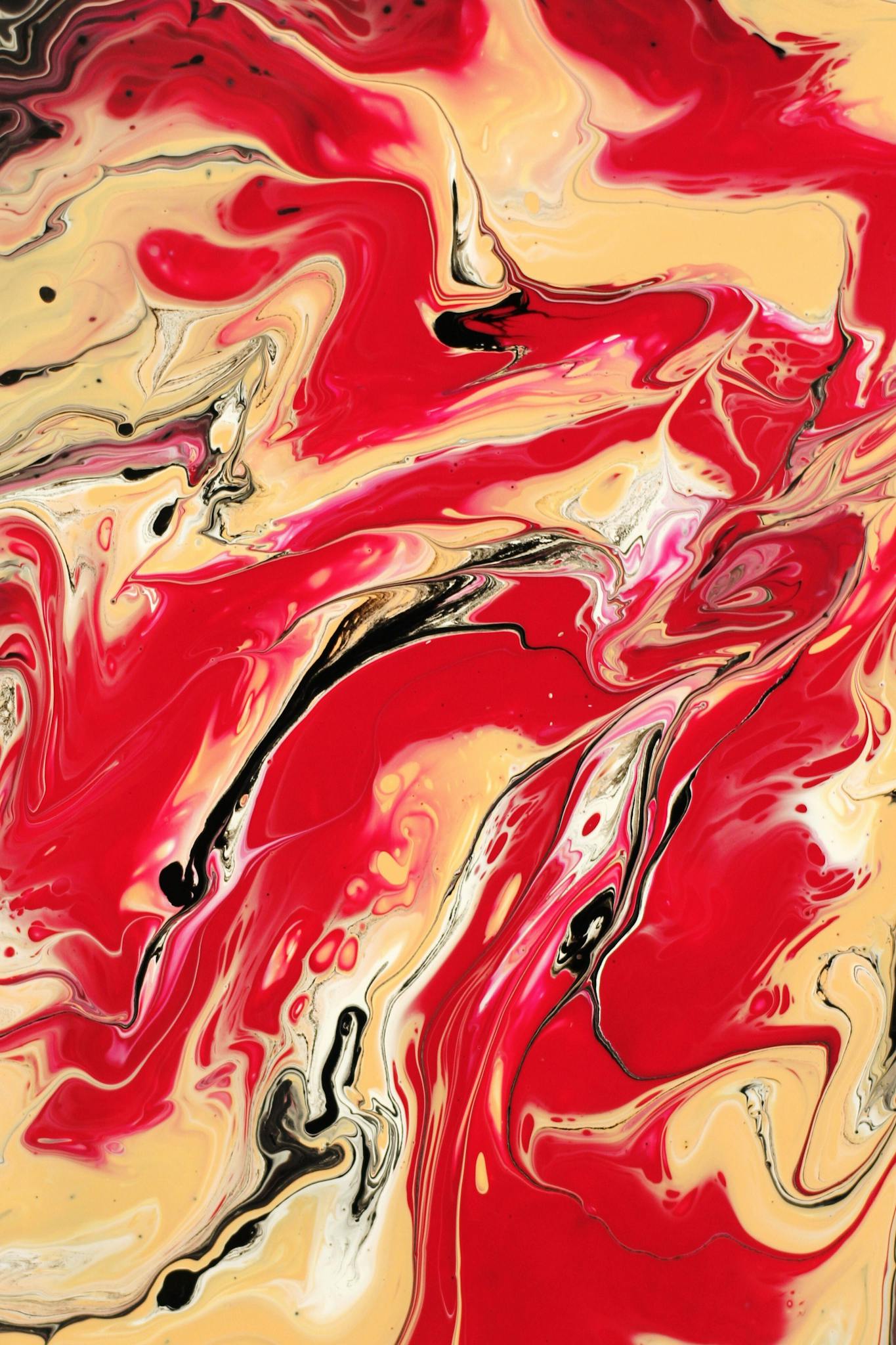 Captivating abstract art with swirling red, beige, and black paint, creating a dynamic and vibrant visual impact.