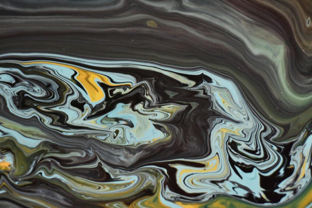Dynamic fluid art painting with vivid swirls and bold colors.